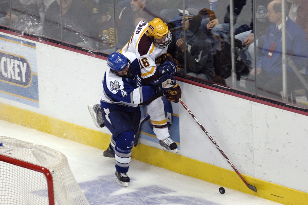 ice hockey players wrangling for puck