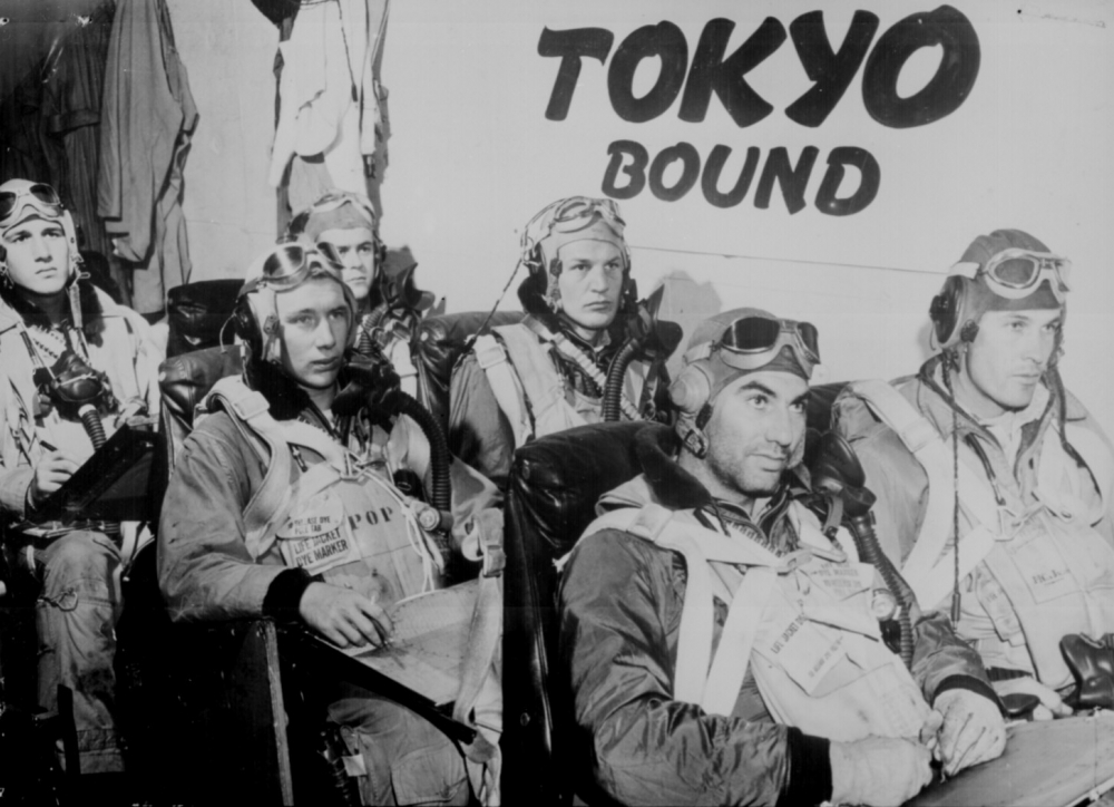 Pilots aboard a U S Navy aircraft carrier receive last minute instructions