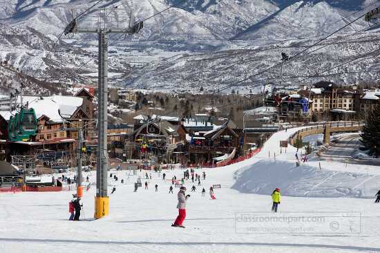 skiers on mountain with view of resort