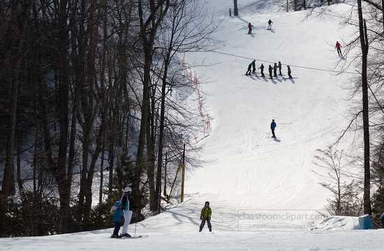 skiiers gathered on mountain slope in colorado