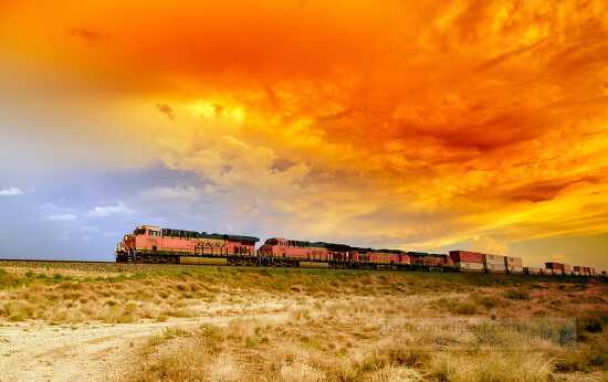 sunset and passing freight train in arizona