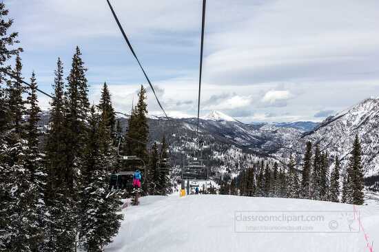 view down snow filled mountain with chair lift