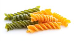 close up of twisted fusilli pasta in different colors