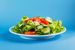fresh healthy garden salad served on a white plate