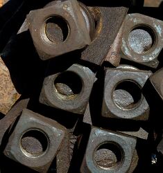 old pile of metal nuts with a weathered appearance
