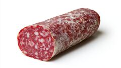 thick cut of cured salami showing its marbled texture