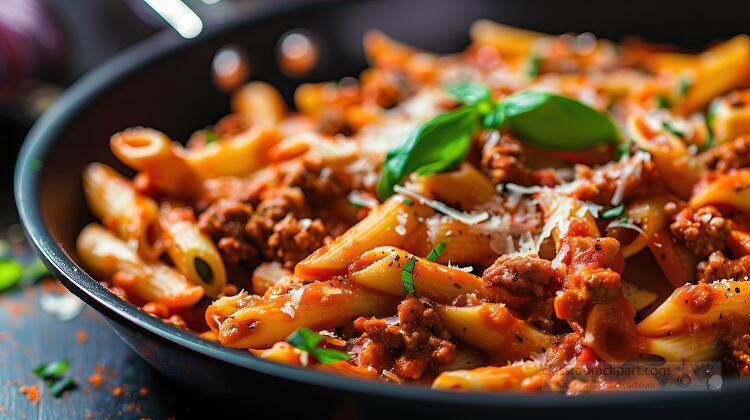 beef penne pasta in tomato sauce in a black pan