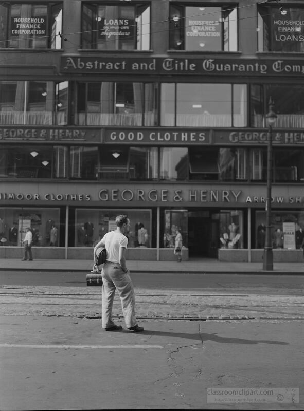 Detroit Michigan Worker stands waiting for a street car 1942