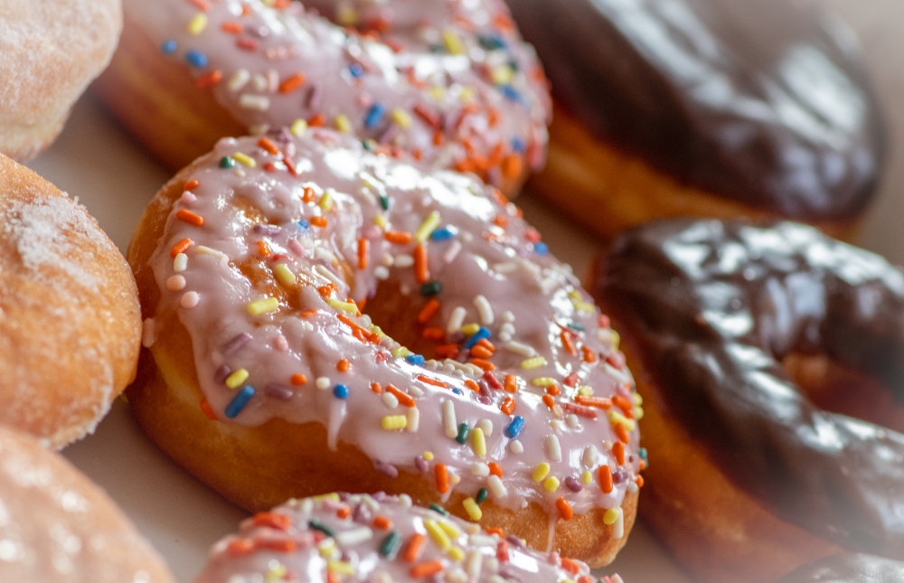 doughnuts covered in icing and sprinkes