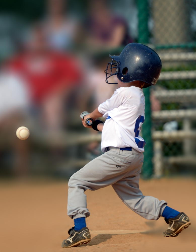 little league hitting ball