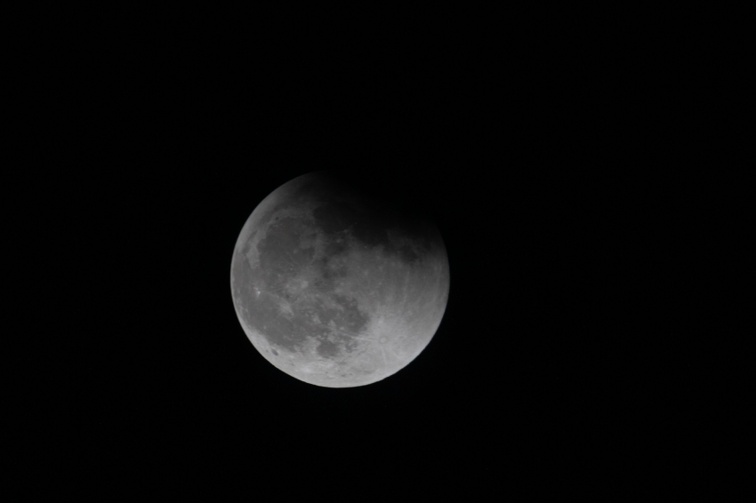 the moon during a lunar eclipse pictured from the space station