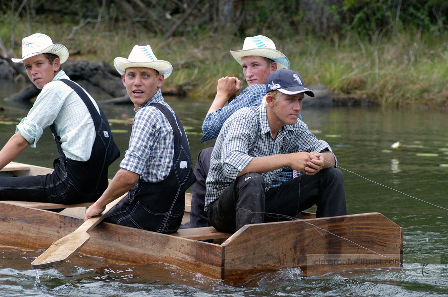 Young men in small boat fishin in river