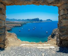 Coastal View of Turquoise Bay and Rocky Cliffs in Rhodes