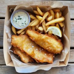 Delicious Fish and Chips Served With Tartar Sauce and Lemon