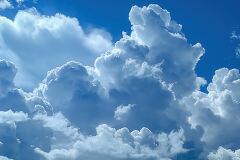 Dramatic Cumulus Clouds Fill Bright Blue Sky at Midday