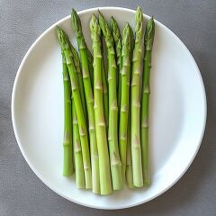 Fresh Asparagus Arranged Neatly on a White Plate