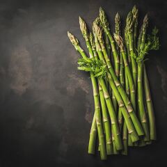 Fresh Asparagus Spears Arranged Artistically on Dark Surface