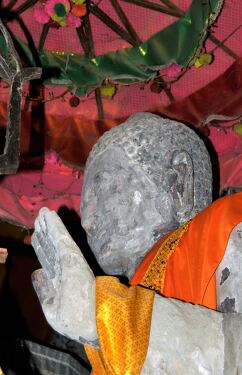 Serene Buddha Statue Adorned in Vibrant Robes at Angkor Wat