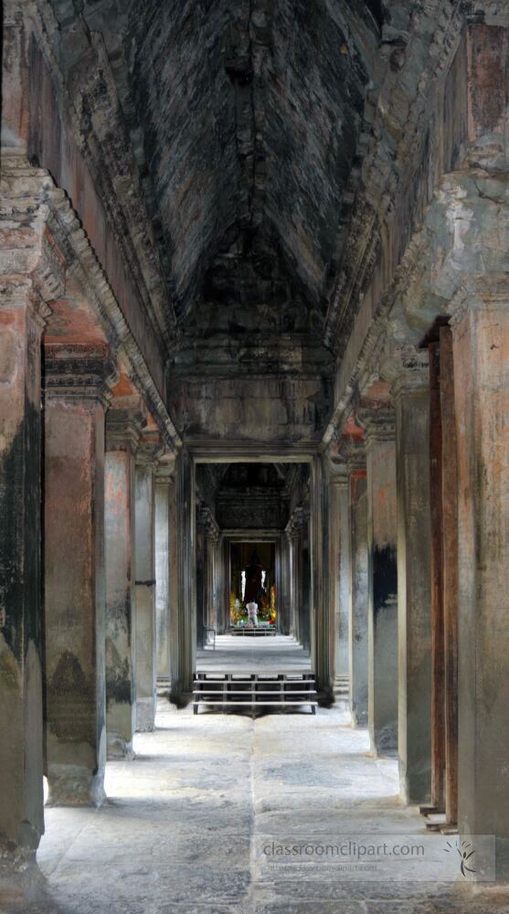 Majestic stone corridors of Angkor Wat reflect the grandeur of ancient Cambodia. Sunlight pours in illuminating the intricate carvings and inviting visitors to explore this historical wonder.