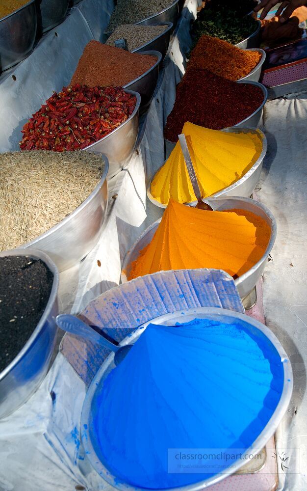 Vibrant bowls of spices and colored powders are arranged in a local market in Aswan Egypt showcasing the rich culinary heritage and trade practices of the region