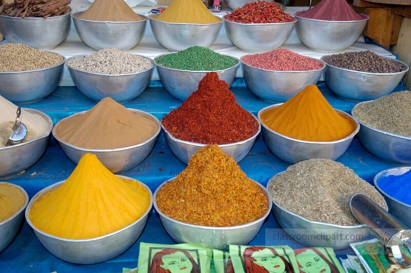 Vibrant bowls of spices are arranged neatly in a market in Aswan Egypt Each bowl showcases a variety of colors and textures illustrating the local trade and culinary tradition