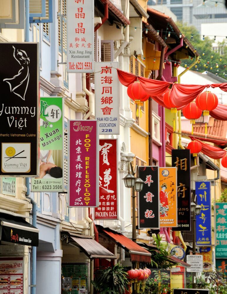 Stroll through the lively streets of Chinatown, Singapore, adorned with colorful lanterns and traditional signs, inviting visitors to explore rich cultural heritage and delightful cuisines.