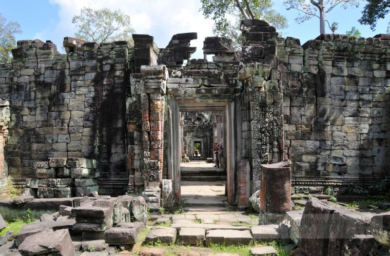 Explore the majestic ruins of Angkor Wat in Siem Reap Cambodia. This UNESCO World Heritage Site features intricate stone structures surrounded by lush greenery inviting visitors to delve into its rich history.