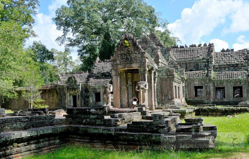 Explore the majestic ruins of Angkor Wat in Siem Reap Cambodia surrounded by lush greenery and a brilliant blue sky inviting travelers to appreciate its timeless charm and intricate architecture.