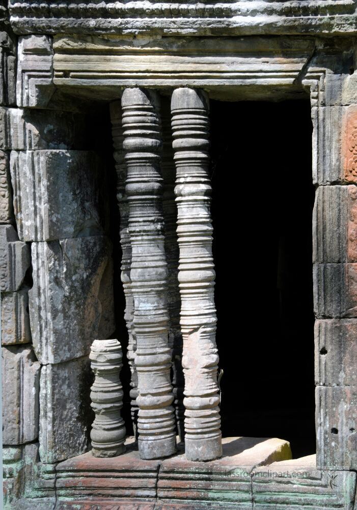 Intricate stone pillars stand timelessly at a doorway in Siem Reap Cambodia. Their weathered surfaces tell stories of the past blending history with the vibrant culture of Angkor Wats renowned architecture.