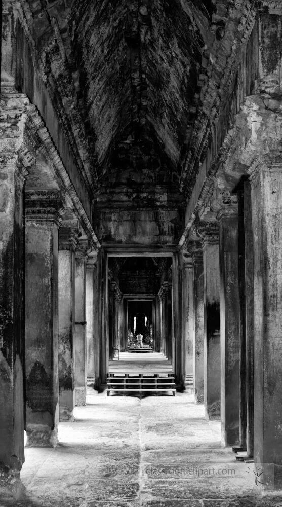 Ancient stone corridors invite visitors into the heart of Angkor Wat where history echoes through each step. Sunlight gently illuminates the weathered walls enhancing the timeless beauty of this Cambodian treasure.