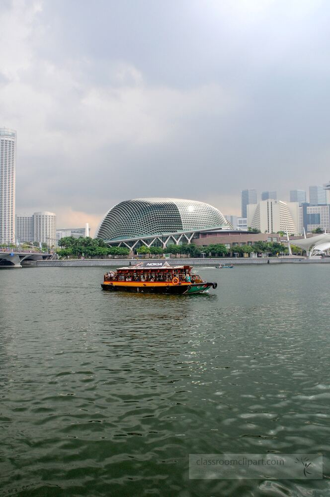 A traditional boat glides over calm waters, with Singapore