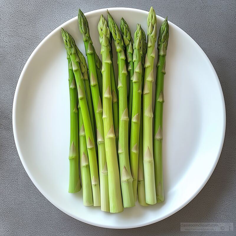 Vibrant green asparagus spears are elegantly laid out on a simple white plate. This presentation highlights the freshness and natural beauty of the asparagus perfect for a healthy meal.