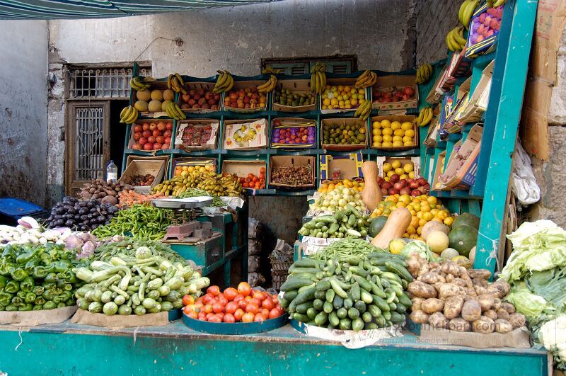 A lively market in Aswan Egypt showcases a variety of fresh fruits and vegetables Vendors display their colorful goods attracting locals and tourists alike to explore the vibrant offerings