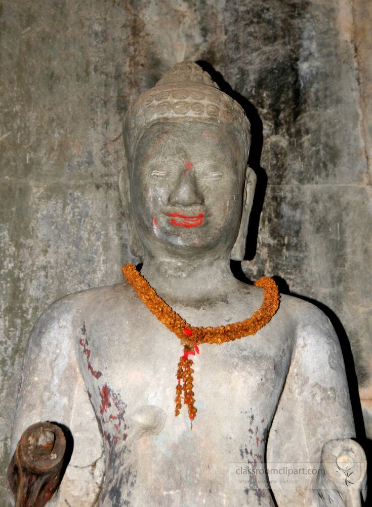 A serene stone statue stands gracefully in Siem Reap Cambodia showcasing intricate details. Adorned with vibrant flowers it reflects the rich culture and spirituality of the region inviting admiration.