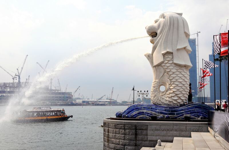 The iconic Merlion statue stands proudly at the harbor, water cascading from its mouth as boats glide by. This vibrant area showcases Singapore