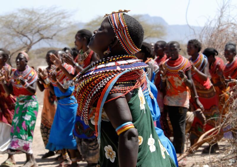 Vibrant Samburu tribe women showcase their rich cultural heritage through traditional dance in the arid landscapes of Kenya Dressed in colorful attire and adorned with intricate jewelry they celebrate community and tradition under the warm sun