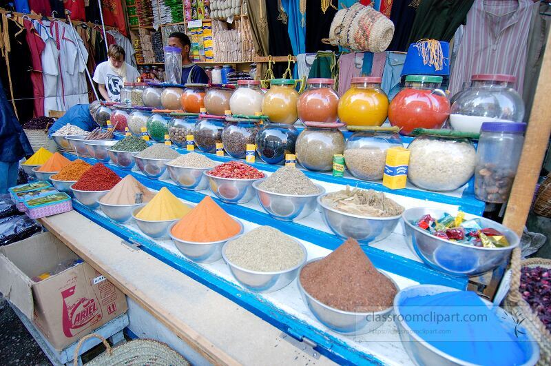 Colorful spices are displayed in bowls at a bustling market in Aswan Egypt Visitors admire the variety while vendors showcase their vibrant offerings under a sunny sky